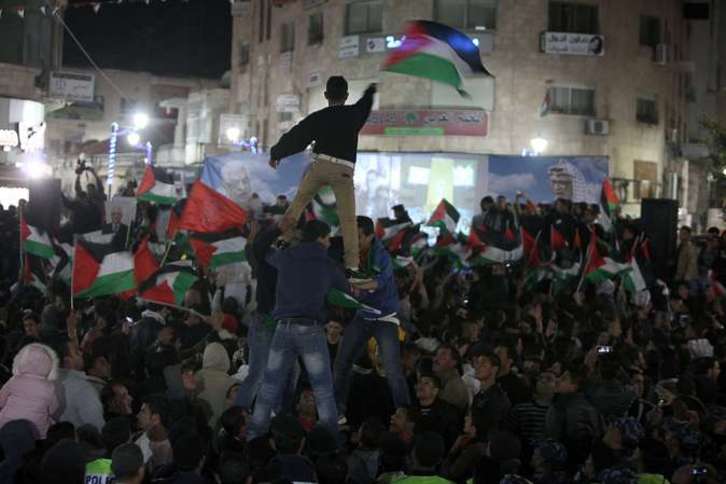 Palestinos celebran la votación de la ONU en las calles de Ramallah. (Abbas MOMANI/AFP)