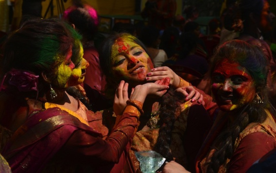 Varias mujeres cubren sus caras con polvos de colores. (Diptendu DUTTA/AFP PHOTO)