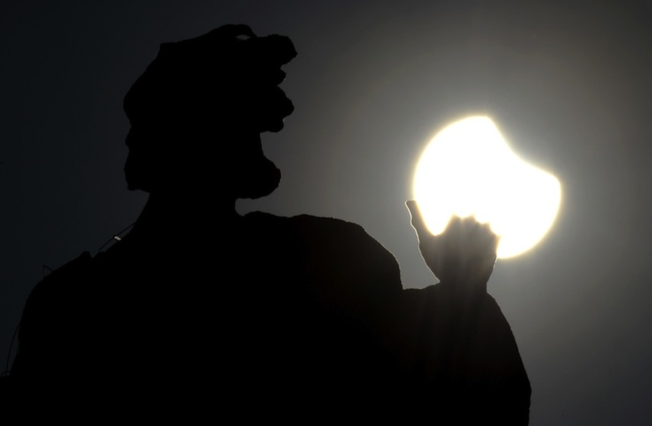 La estatua del Vaticano, con el eclipse en el fondo. (Andreas SOLAR/AFP)