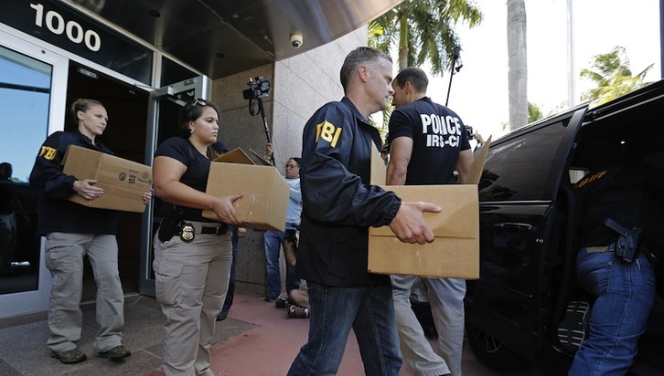 Agentes del FBI se llevan cajas de la sede de la Concacaf en Miami. (Joe SKIPPER  / AFP)