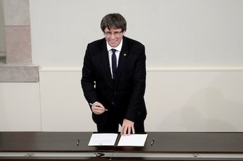 El president de Catalunya, Carles Puigdemont, firma de la declaración de independencia. (Lluís GENÉ/AFP)