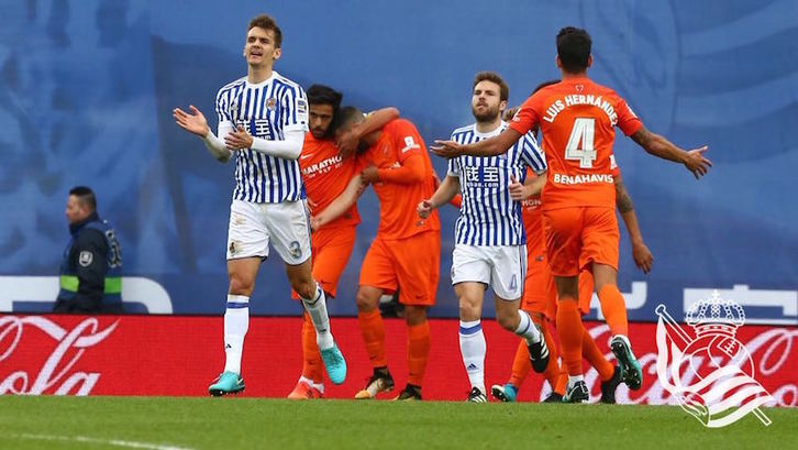 Llorente trata de animar a los suyos mientras jugadores del Málaga celebran un gol. (@RealSociedad)