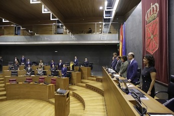 Parlamentarios en pie en el minuto de silencio por la última muerte en accidente laboral en el herrialde. (PARLAMENTO DE NAFARROA)