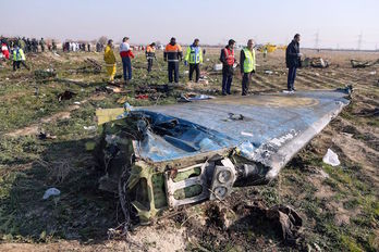 Equipos de rescate e investigación junto a restos del avión siniestrado. (Akbar TAVAKOLI/AFP)