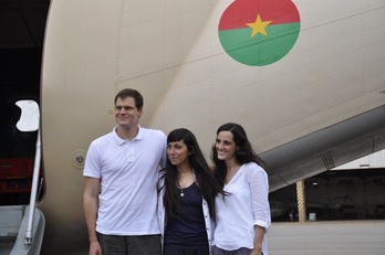 Enric Gonyalons, Ainhoa Fernández y Rossella Urru ante el avión que les ha trasladado a Burkina Faso. (Ahmed OUOBA/AFP) 
