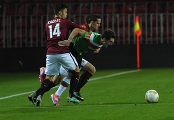 Ibai Gómez pugna entre dos jugadores del conjunto de Praga. (Michal CIZEK/AFP PHOTO)