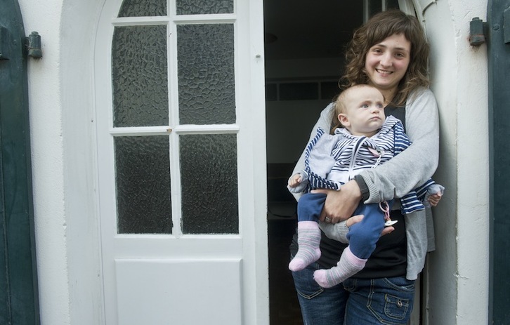 Otaegi, Oihana zazpi hilabeteko alaba eskuan duela, bere etxeko atarian. (Jon URBE/ARGAZKI PRESS)