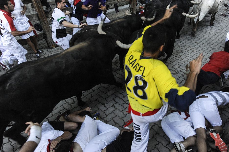 Un corredor salta entre el gentío para evitar a los toros. (Jagoba MANTEROLA/ARGAZKI PRESS)