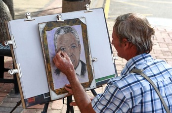 Un dibujante hace un retrato de Nelson Mandela en una playa de Durban. (Rajesh JANTILAL/AFP)