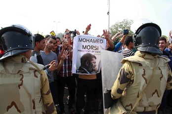 Miembros de las fuerzas de seguridad, frente a simpatizantes de Morsi. (Khaled KAMEL/AFP PHOTO)