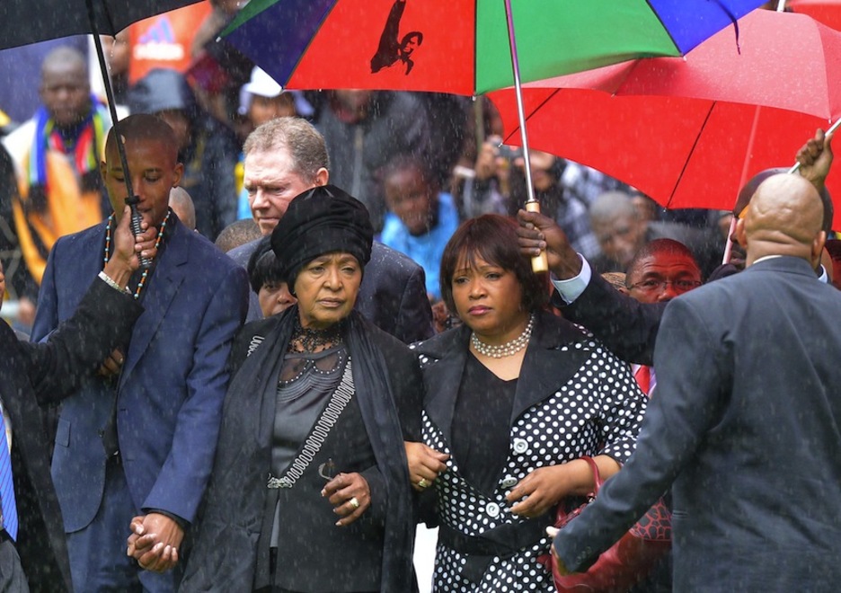 El nieto, la segunda esposa y la hija del exmandatario, en el funeral. (Alexander JOE/AFP)
