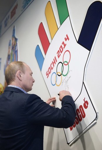 El presidente ruso, Vladimir Putin, estampa su firma en un logotipo de los juegos. (Alexey NIKOLOSKY/AFP)