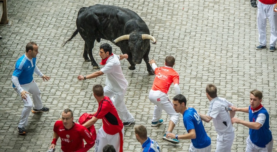 Los corredores tratan de llevar hacia el coso al toro rezagado. (Gorka RUBIO / ARGAZKI PRESS) (