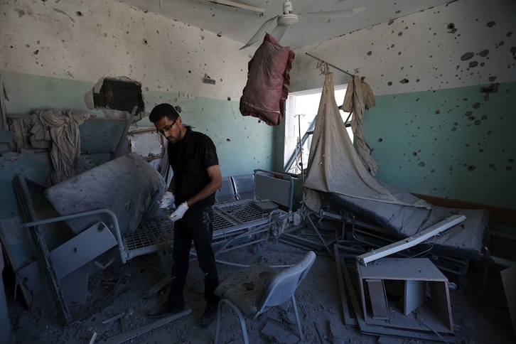 Un trabajador palestino observa los destrozos causados por el bombardeo en el hospital Al-Aksa. (Mohamed ABED/AFP) 