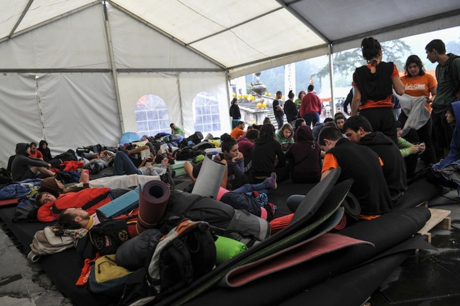 Los sacos y las esterillas se amontonan en la carpa.