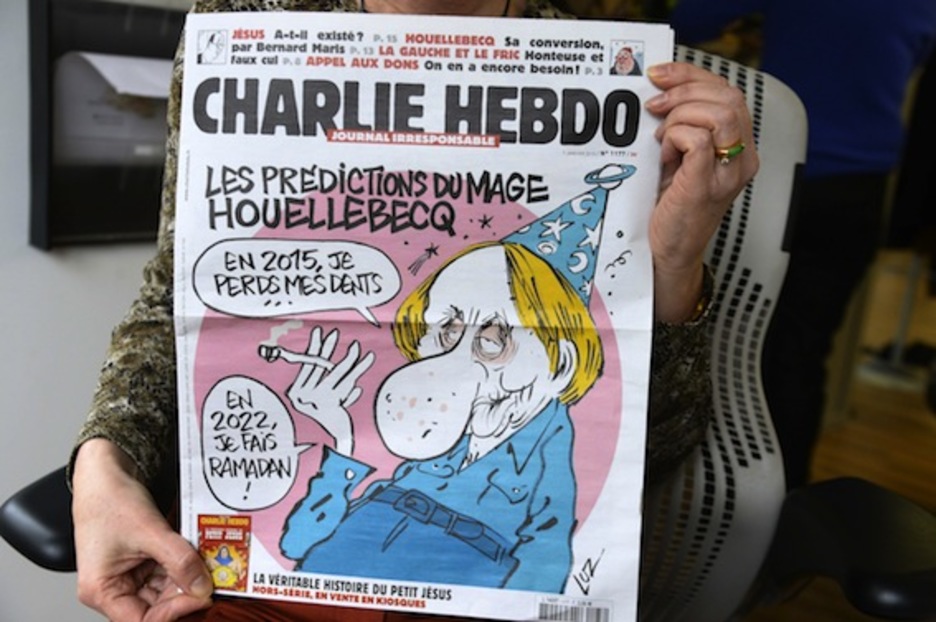 Una mujer sostiene el último ejemplar de ‘Charlie Hebdo’. (Bertrand GUAY/AFP PHOTO)