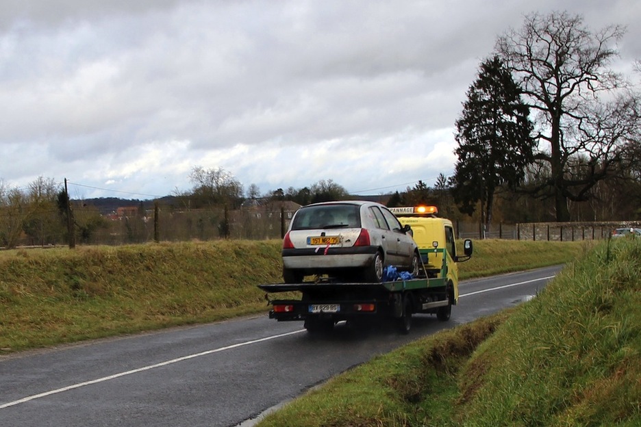 Una grúa retira el Renault Clio en el que huyeron anteayer los atacantes de ‘Charlie Hebdo’. (Perrine VERSCHMELDEN / AFP)  