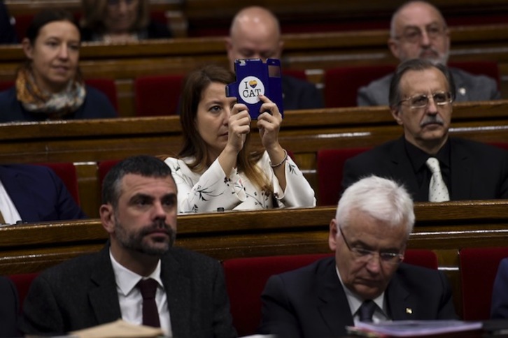 Una diputada de Ciudadanos toma una imagen con su móvil durante la sesión matinal. (Josep LAGO / AFP)