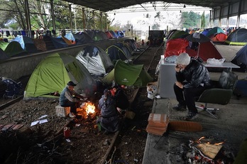 Estos refugiados han encontrado un lugar en el que resguardarse de la lluvia en esta antigua estación de tren en Idomeni, Grecia. (DANIEL MIHAILESCU / AFP)