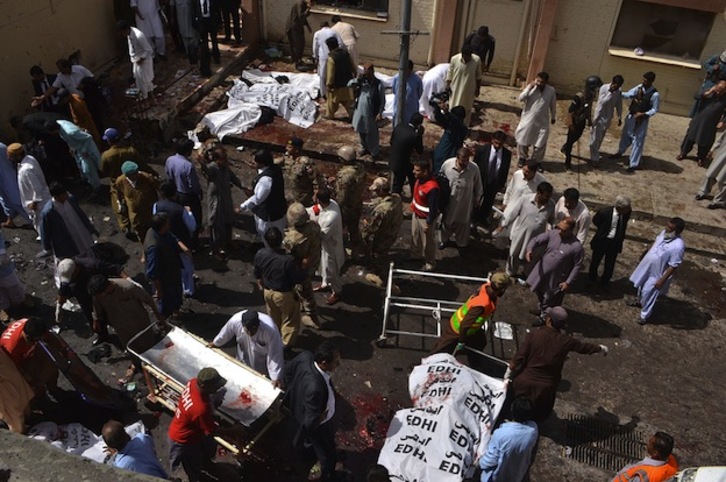 Cuerpos cubiertos y restos de sangre en el lugar del atentado. (BANARAS KHAN / AFP)
