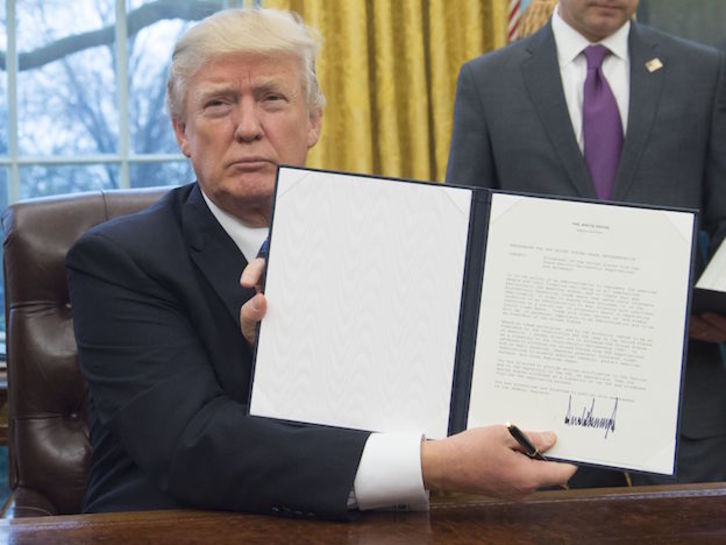 Donald Trump muestra el documento que saca a EEUU del Acuerdo Transpacífico. (SAUL LOEB / AFP)