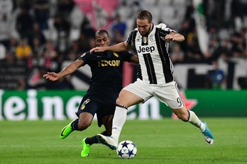 El delantero juventino Gonzalo Higuaín lucha por un balón con Djibril Sidibe. (Miguel MEDINA/AFP PHOTO)