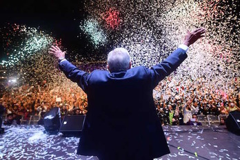 López Obrador saluda desde el escenario a los miles de seguidores congregados en el Zócalo para festejar la victoria. (Pedro PARDO/AFP)