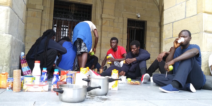 Los migrantes, de origen africano, han desayunado en los soportales del Ayuntamiento de Irun. (SOS Racismo)