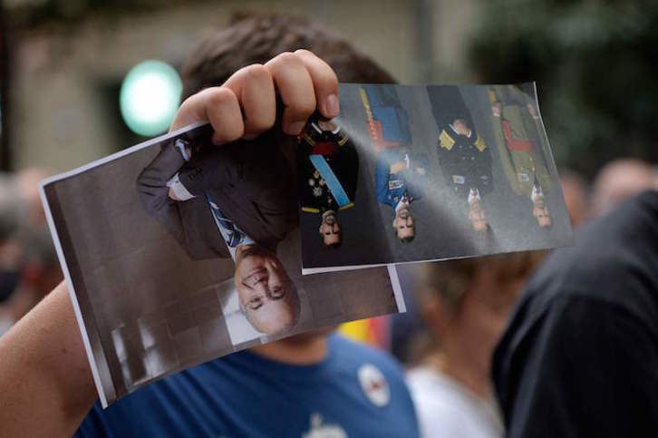 Una foto del magistrado Pablo Llarena, junto a otras de Felipe de Borbón, durante una protesta en Barcelona. (Josep LAGO/AFP)