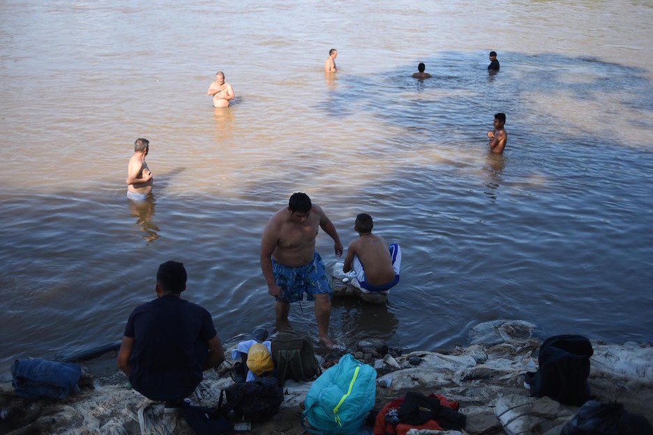 Un grupo de personas toma un baño en Ciudad Tecun Uman, Guatemala. (Johan ORDÓÑEZ/AFP)