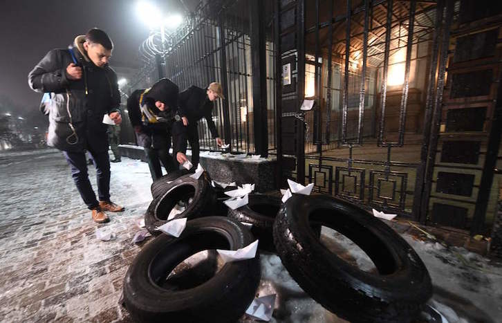 Ukrainarrek paperezko itsasontziak utzi dituzte Kieven Errusiak duen enbaxadaren aurrean. (Sergei SUPINSKY/AFP)