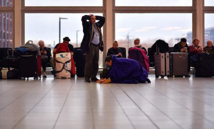 Una de las imágenes más repetidas en Gatwick estos pasados días, la de pasajeros en espera. (Ben STANSALL/AFP)