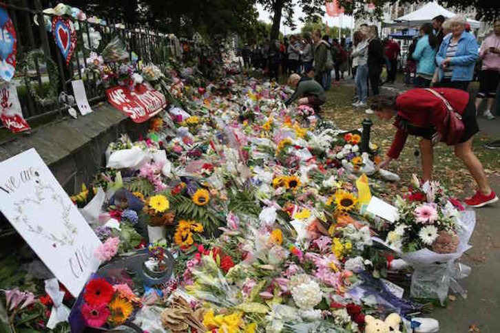 Habitantes de Christchurch depositan flores en recuerdo a las víctimas. (DAVID MOIR / AFP)