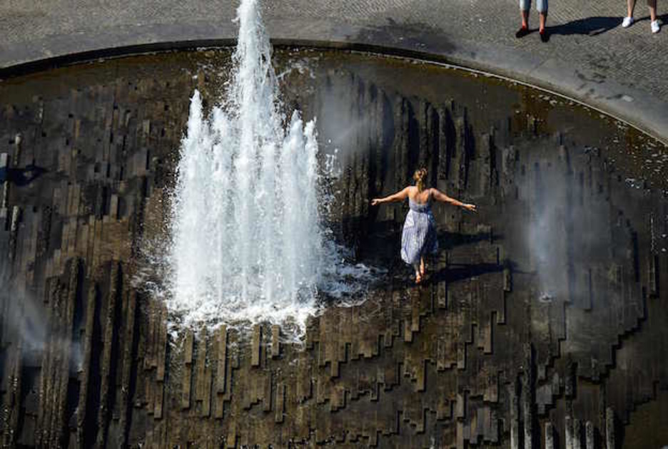 Una mujer se refresca en Berlín. (TOBIAS SCHWARZ/ AFP)