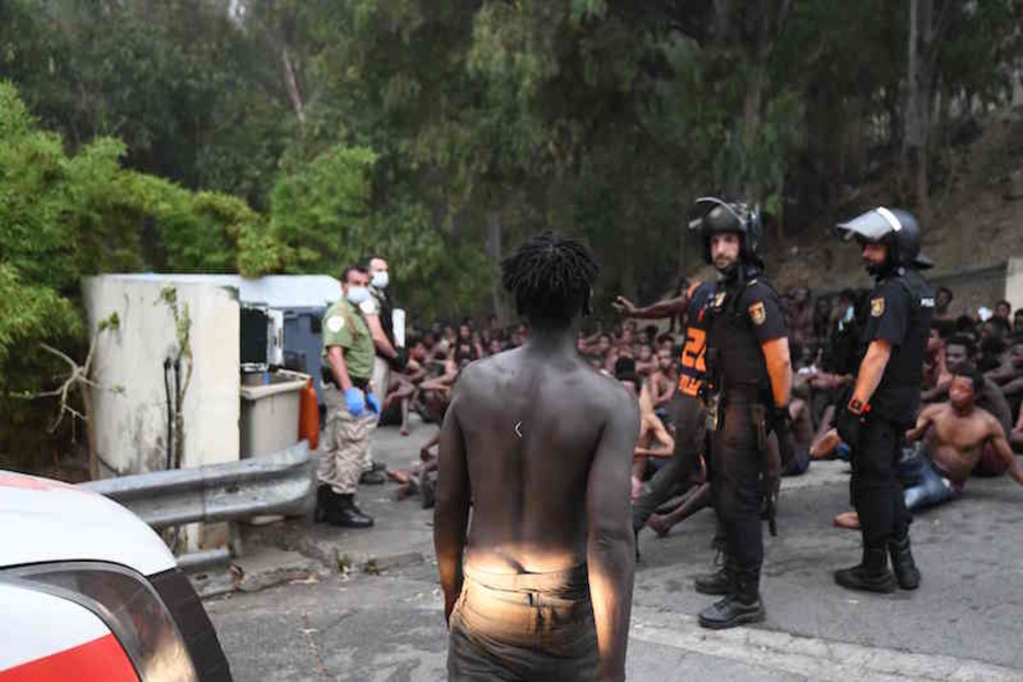 Los migrantes detenidos aguardan su traslado al centro de internamiento temporal de la localidad. (Antonio SEMPERE/AFP)