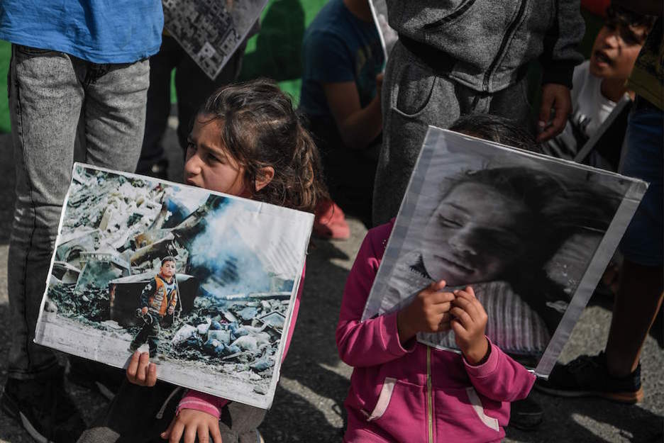 Carteles contra la invasión turca en un campo de refugiados al norte de Atenas, en Grecia. (LOUISA GOULIAMAKI / AFP)
