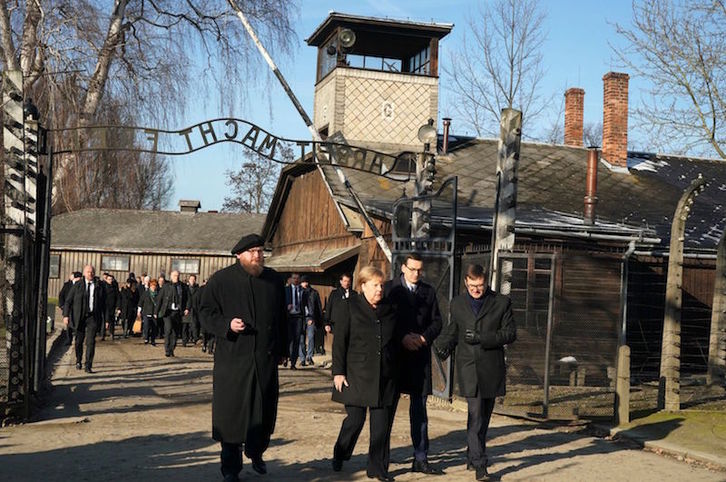 La canciller Angela Merkel junto al primer ministro polaco, Mateusz Morawiecki, y el director del museo estatal de Auschwitz-Birkenau, Piotr Cywinski. (Janek SKARZYNSKI / AFP)