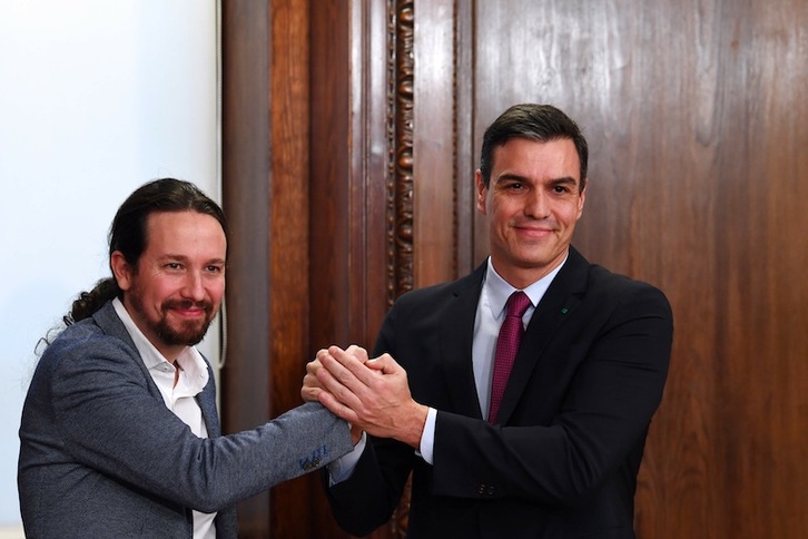 Iglesias y Sánchez, al presentar el Gobierno de coalición. (Gabriel BOUYS | AFP)