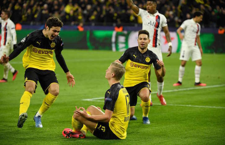 Los jugadores del Dortmund se aproximan a Haaland para celebrar uno de los goles. (Ina FASSBENDER/AFP)