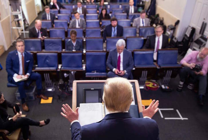 Los periodistas mantienen las distancias en una rueda de prensa de Donald Trump. (JIM WATSON / AFP) 