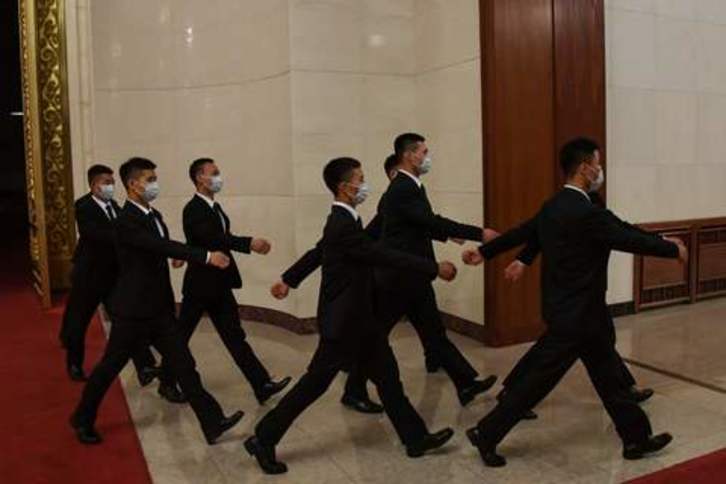 Un grupo de agentes de seguridad vigilando la celebración de la asamblea china anual. (Leo REMIREZ/AFP)