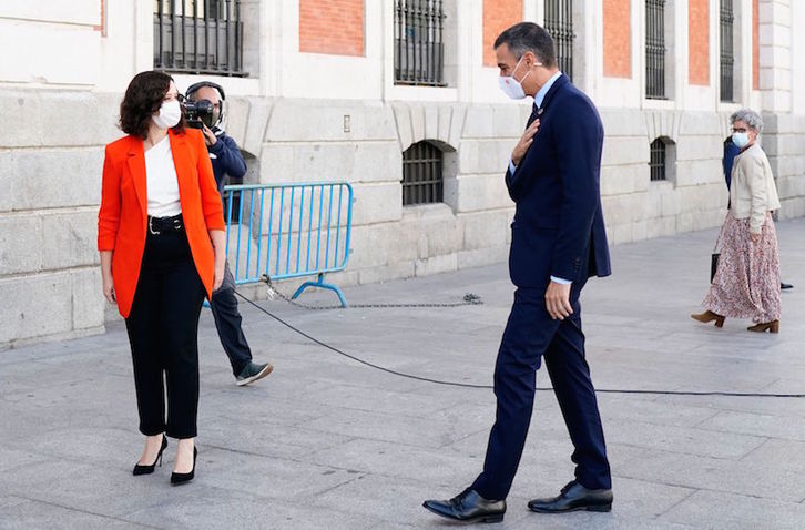 La presidenta madrileña y el español, en Puerta del Sol. (AFP)