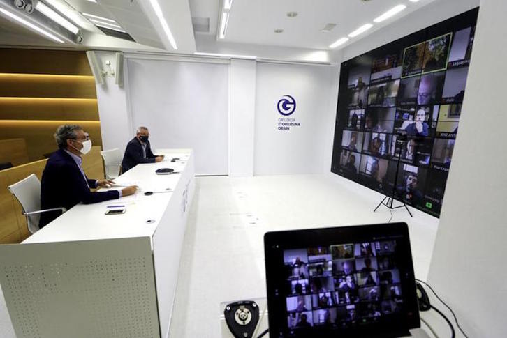 Olano y Asensio, con los alcaldes y alcaldesas al otro lado del plasma. (Gipuzkoako Aldundia)