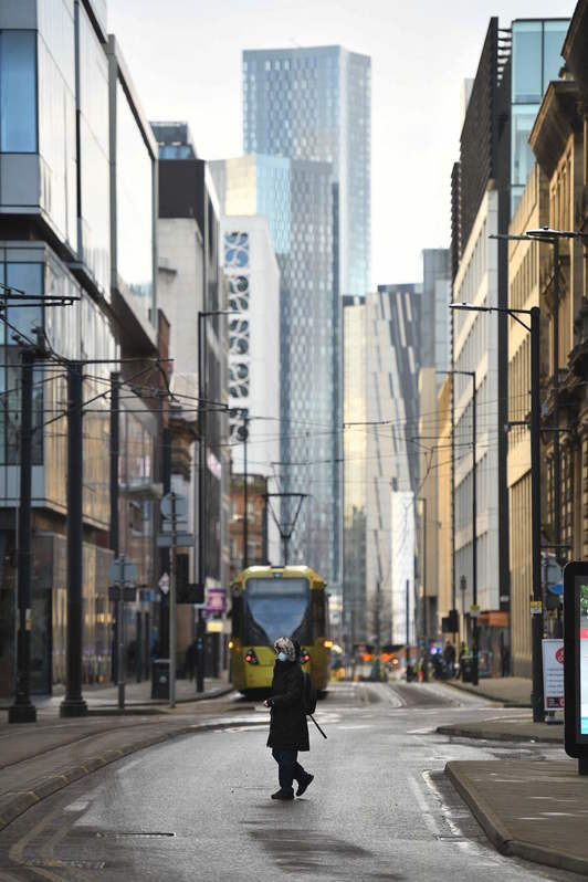 Una mujer pasea por las calles desieras de Londres, donde la cepa británica se ha vuelto hegemónica. (Oli SCARFF/AFP)
