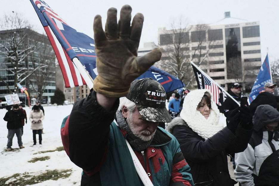 Los partidarios del presidente Donald Trump se unen en una oración masiva frente al Capitolio Estatal de Michigan. (Matthew HATCHER/AFP)