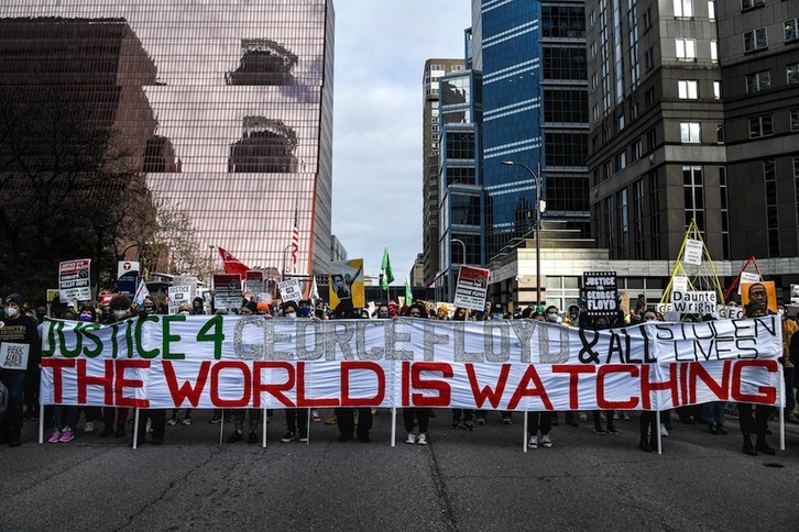 En la pancarta que encabezaba una de las manifestaciones que se realizaron este lunes en Mineápolis se lee, en grandes letras, «El mundo está observando». (Chandan KHANNA | AFP)