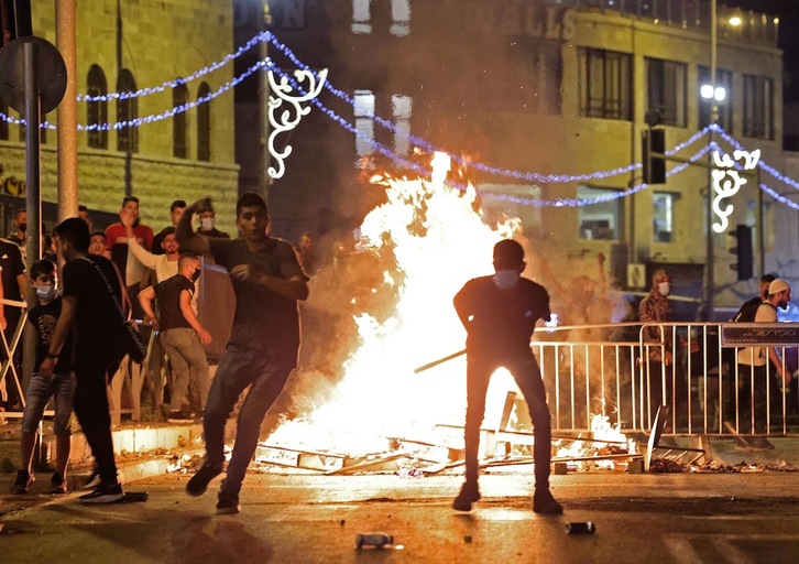 Manifestantes palestinos arrojan piedras a la Policía israelí durante los enfrentamientos en la Ciudad Vieja de Jerusalén, el pasado sábado. (Emmanuel DUNAND | AFP)