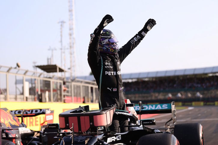 Lewis Hamilton alza los brazos tras lograr el mejor tiempo para la calificación de carrera sprint. (Lars BARON/AFP)