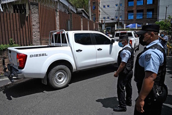 Vehículos del Instituto de Medicina Legal salen de la casa del expolicía Osorio. (Marvin RECINOS/AFP) 
