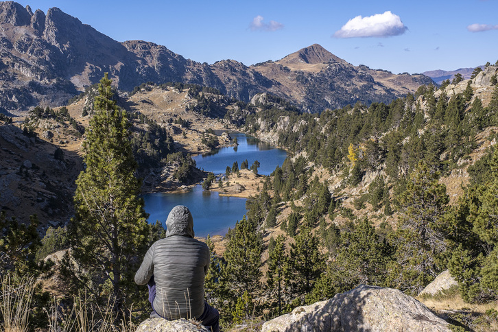 Lakuaren handitasunaren aurrean, eserita.